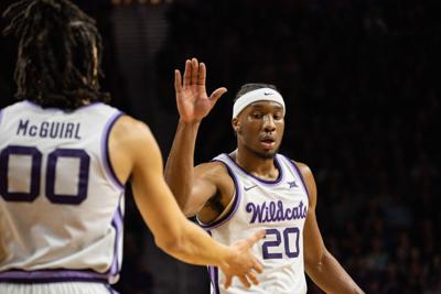 Xavier Sneed (20) high fives Mike McGuirl (00) after McGuirl drew a foul on the prior play.